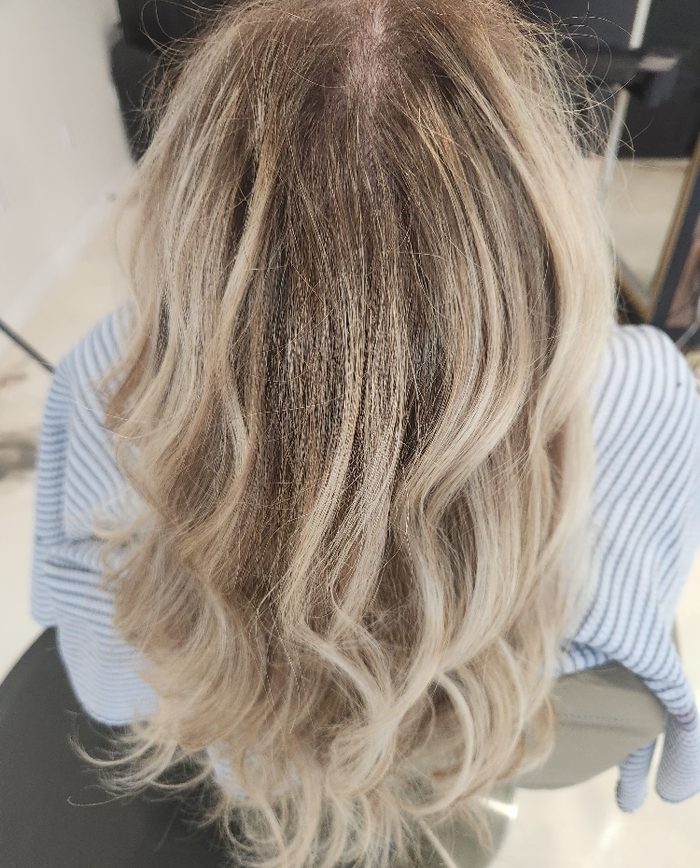 Soft, lived-in blonde color on long wavy hair